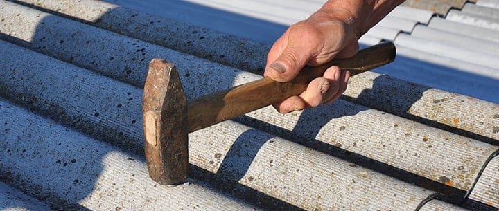 roofer working with asbestos shingles