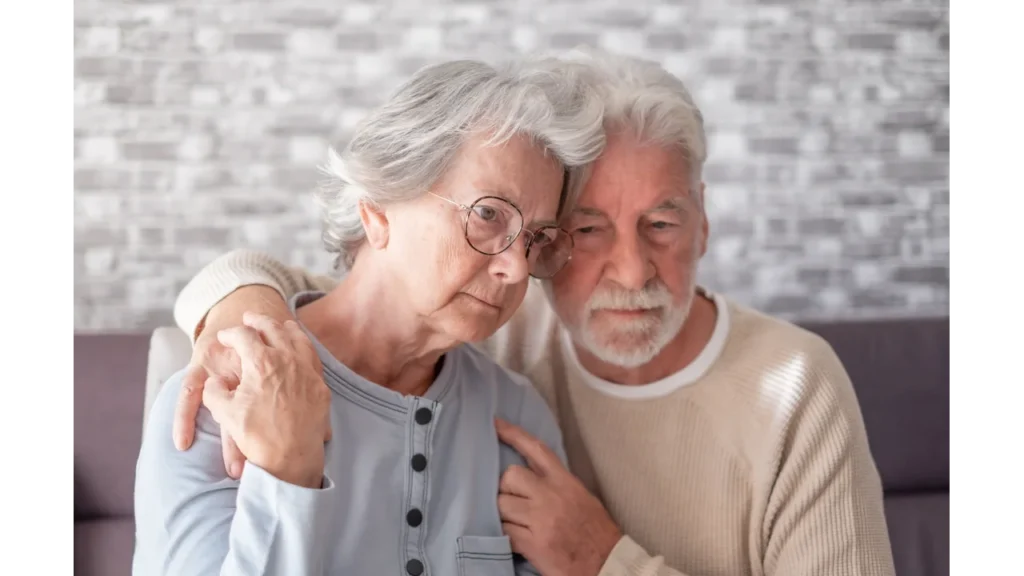 An elderly couple sharing a moment of connection in an office