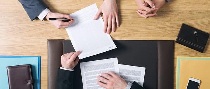 Asbestos Lawyer reviewing case documents with a client.