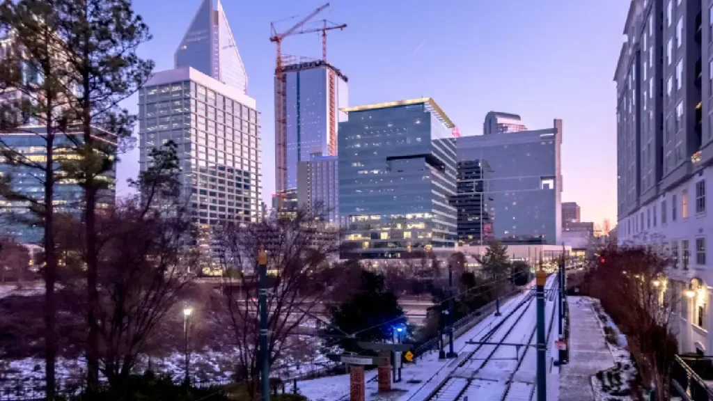 A picturesque city skyline with a layer of snow covering the ground, highlighting the beauty of winter in the city