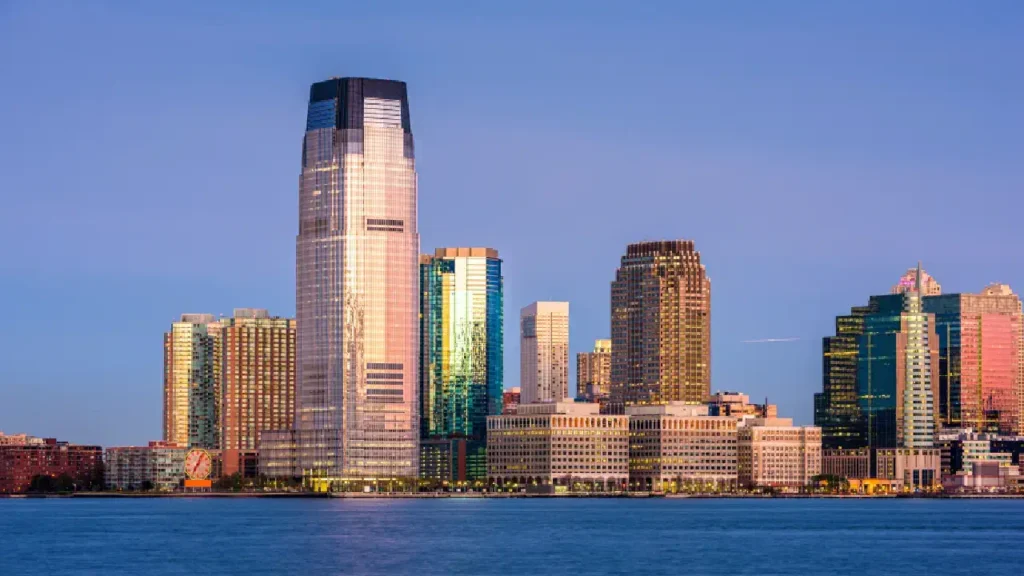 The New York City skyline illuminated at dusk, featuring its famous skyscrapers and a colorful evening sky