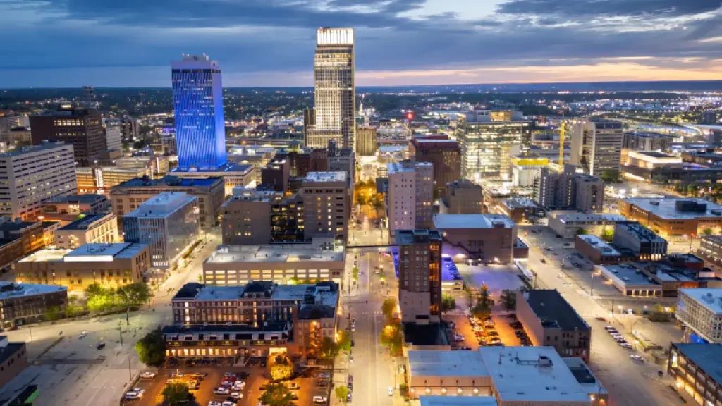 Omaha city skyline at dusk, showcasing illuminated buildings against a twilight sky, symbolizing urban beauty
