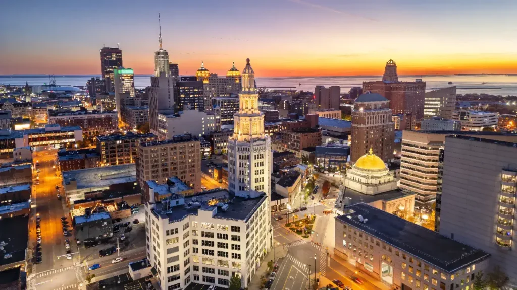 A vibrant city skyline glows with sunset hues, blending modern architecture and natural beauty