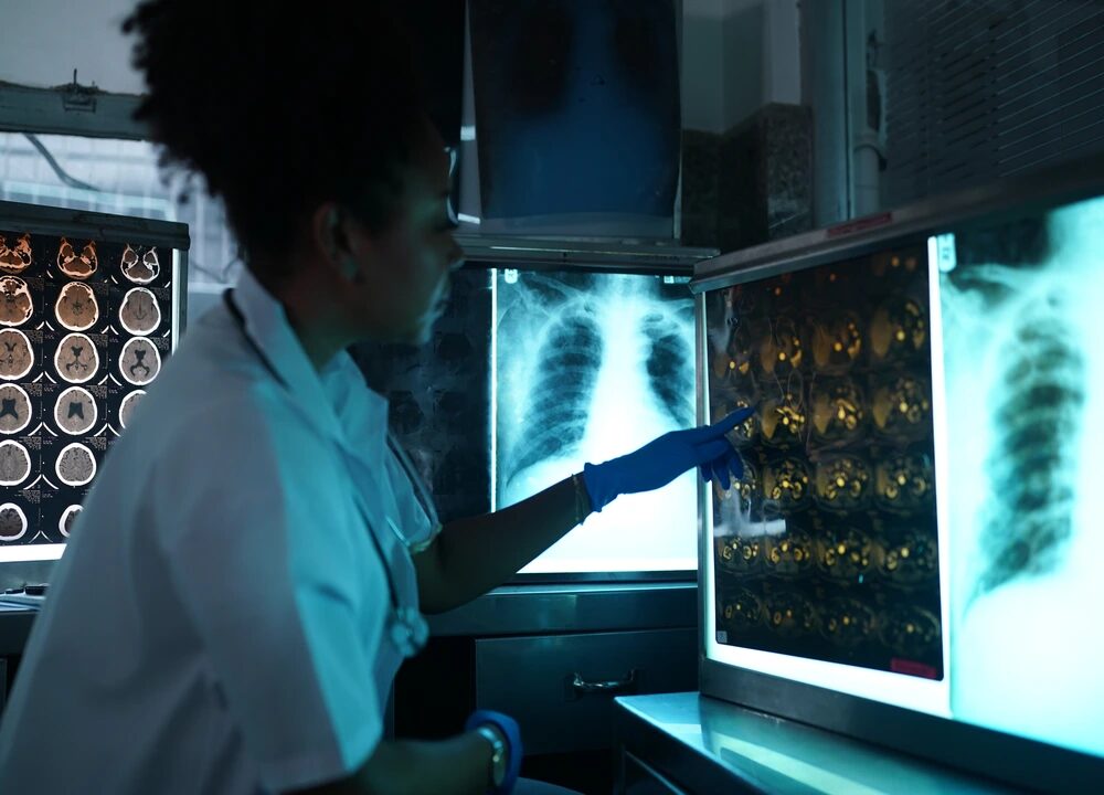 A female medical professional studies an X-ray in a lab