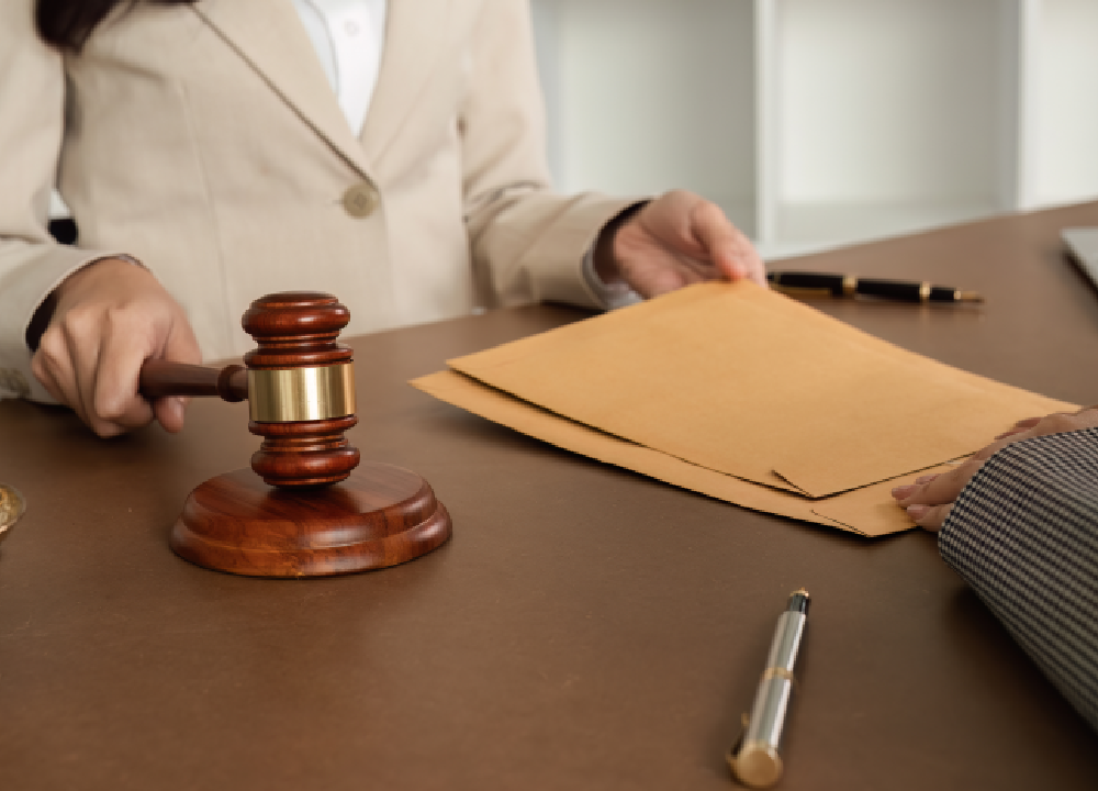 Lawyer with a gavel and legal documents on a desk.