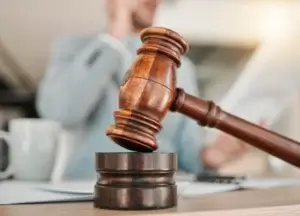 Lawyer with a gavel and legal documents on a desk.