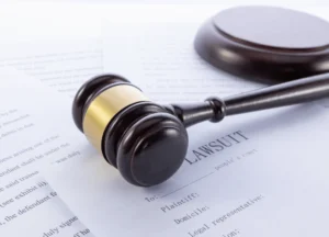 Close-up of a legal document titled ‘Lawsuit’ with handwritten notes on paper