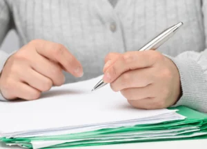 attorneys reviewing files and evidence together at a conference table.