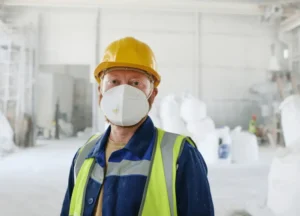 Construction worker wearing protective gear against asbestos