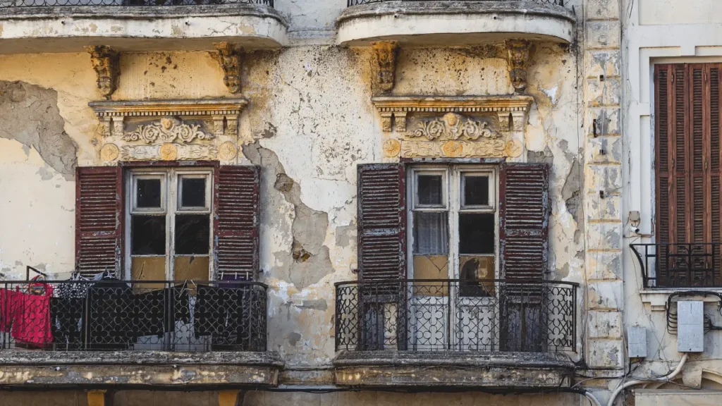 Exterior of an aging apartment building with asbestos risk