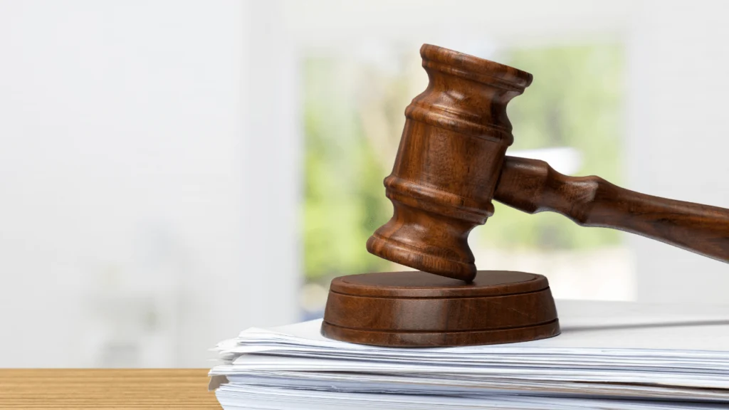 Legal gavel and asbestos fibers - Can I Sue for Asbestos Exposure? Asbestos Lawsuits & Payouts.