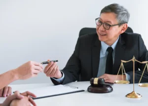 Lawyer explaining legal paperwork to a Navy veteran about a mesothelioma claim.