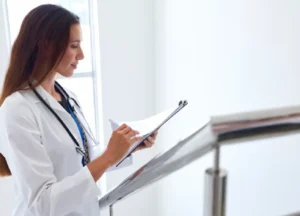 “Female doctor reviewing patient notes