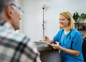 Doctor or nurse checking in with a patient during a follow-up appointment for mesothelioma and asbestosis care