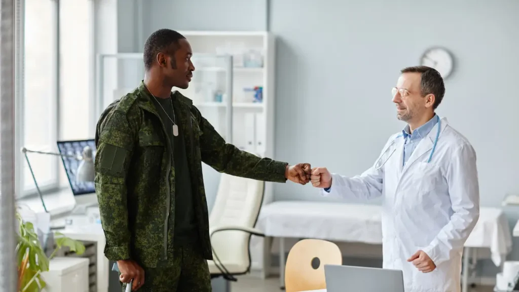 Veteran receiving medical care from a doctor in a VA clinic, illustrating healthcare access for military veterans.
