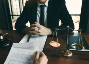 Veteran meeting with a lawyer at an office, reviewing legal documents and discussing VA benefits, trust funds, and advocacy support.