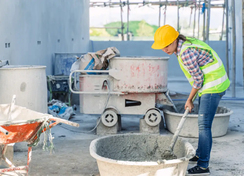 Construction worker mixing cement on a job site, illustrating tasks where asbestos exposure commonly occurred.
